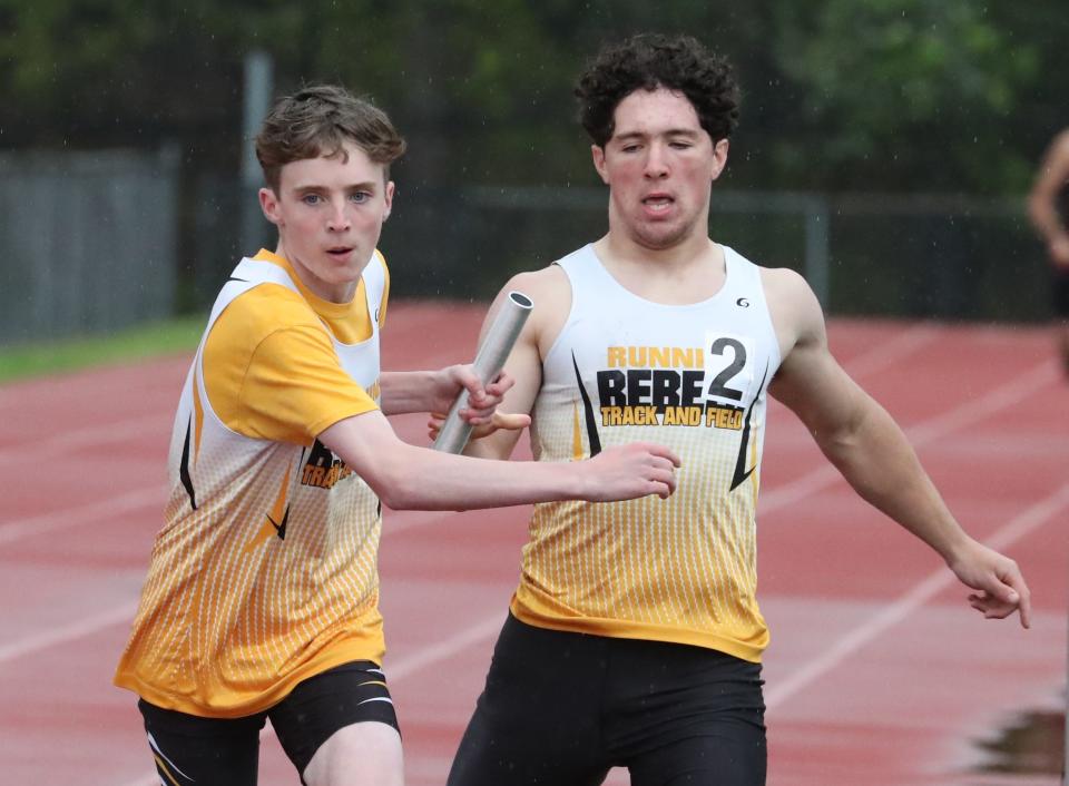 Walter Panas' Bobby Myclin takes the baton from Brian Martins on their way to winning the sprint medley relay at the Somers Joe Wynne track and field invitational May 6, 2022.