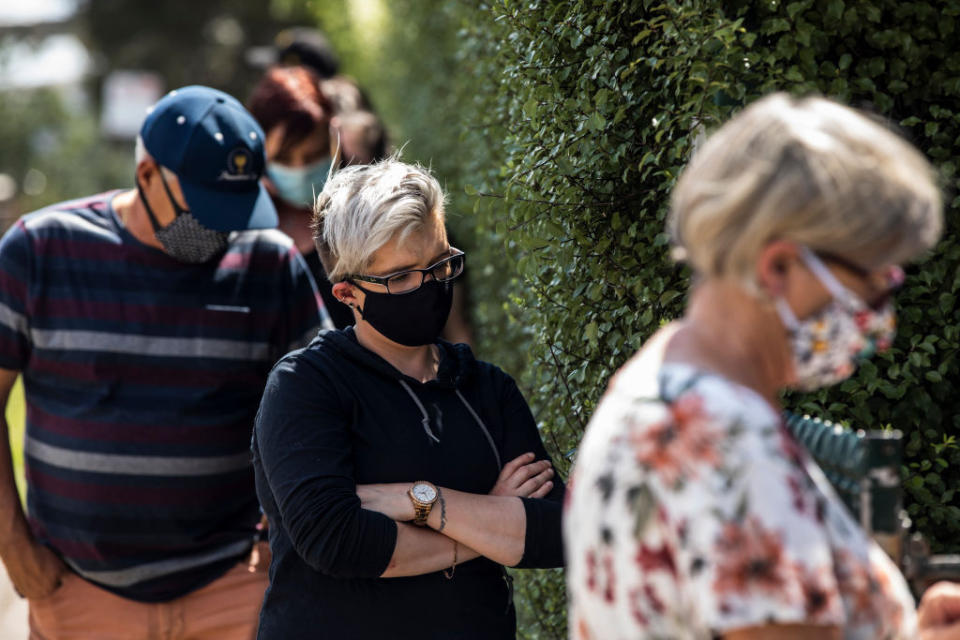 MELBOURNE, AUSTRALIA - FEBRUARY 10: A woman wears a face mask while she waits for a COVID-19 test outside the Sunbury Respiratory Clinic on February 10, 2021 in Melbourne, Australia. Victorians have been warned to remain on alert for coronavirus symptoms following new COVID-19 cases detected in the community linked to the Holiday Inn quarantine hotel. All residents have now been moved to another quarantine hotel while health authorities deep clean the Holiday Inn and investigate the source of transmission. (Photo by Diego Fedele/Getty Images)