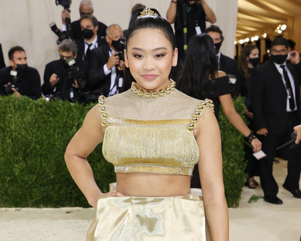 Suni wears an embellished gold crop top and ball gown skirt to a gala