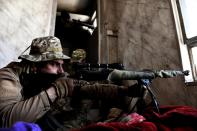 An Iraqi sniper aims his weapon towards Islamic State (IS) fighters during clashes in west Mosul, on March 7, 2017