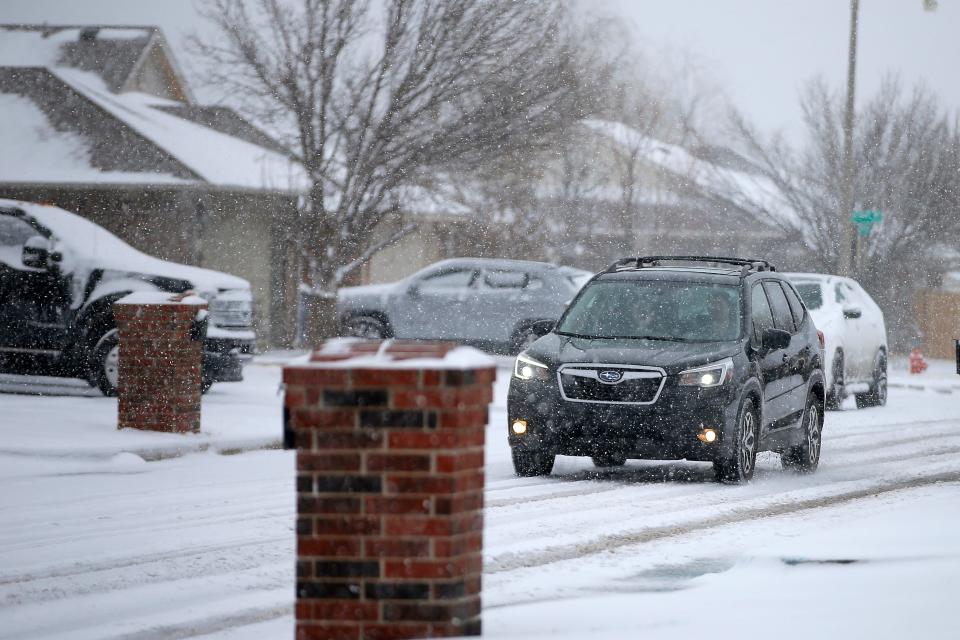 A vehicle drives through the snow March 11, 2022, in a northwest Oklahoma City neighborhood. According to the 2023 version of the Farmers' Almanac, Oklahomans could see snow before the holidays this year.