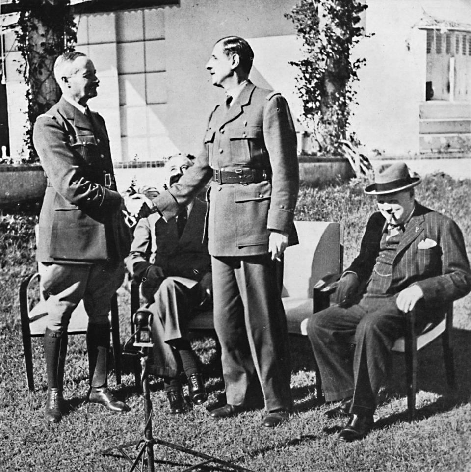 General Henri Honore Giraud and General Charles De Gaulle shake hands in front of American President Franklin Delano Roosevelt and British Prime Minister Winston Churchill at the Casablanca Conference. From Winston Churchill: His Life in Pictures, by Ben Tucker. [Sagall Press, Ltd., London, 1945]