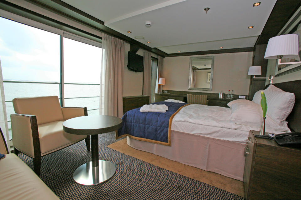 This undated image released by Avalon Waterways shows the interior of a suite, featuring a sliding glass door and french balcony on the river ship Avalon Felicity. The small scale of river ships, which typically carry no more than a couple hundred passengers, is a large part of their appeal, in contrast to ocean-going mega-ships that carry thousands. On a river ship, you don’t need a GPS device to figure out where the lobby or the dining room is. And there’s a sense of intimacy, with plenty of cozy moments. (AP Photo/Avalon Waterways)