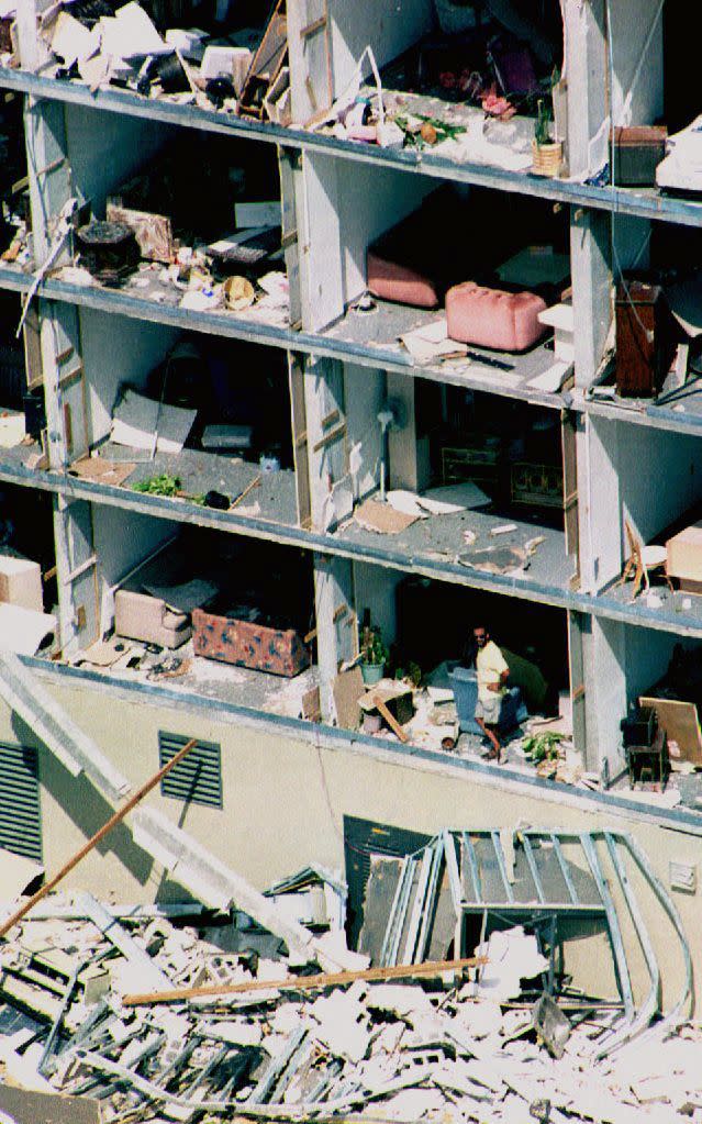 HURRICANE ANDREW, 1992:  Hurricane Andrew is considered to be one of the costliest natural disasters ever to strike the U.S., causing at least $26 billion in damages. The hurricane was a category 5 when it struck Dade County, Florida. A resident (bottom right) looks out of his apartment that had its walls blown away by Hurricane Andrew. About 50,000 Dade county residents are without their homes due to Hurricane Andrew, which struck the area on August 24, 1992.  (ROBERT SULLIVAN/AFP/Getty Images)