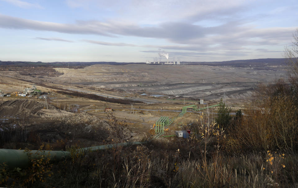 The Turow lignite coal mine near the town of Bogatynia, Poland, Tuesday, Nov. 19, 2019. The Turow lignite coal mine in Poland has an impact on the environment and communities near the border of three neighboring countries, the Czech Republic, Germany and Poland. Plans to further expand the huge open pit mine have caused alarm among residents who fear things might get even worse. (AP Photo/Petr David Josek)