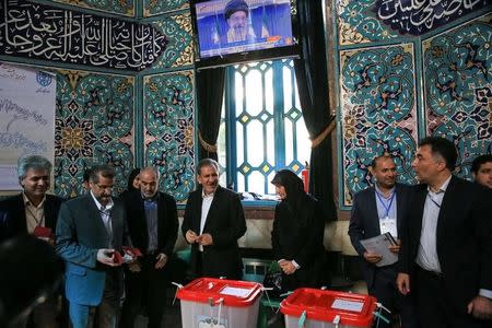 Iranian Vice-President Eshaq Jahangiri and his wife stand after casting their votes during the presidential election in Tehran, Iran, May 19, 2017. TIMA via REUTERS