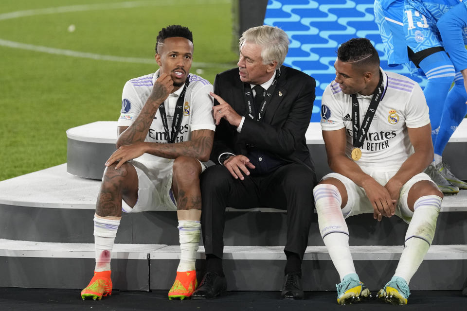 Real Madrid's head coach Carlo Ancelotti, centre, speaks with his players Casemiro, right, and Eder Militao after winning the UEFA Super Cup final soccer match between Real Madrid and Eintracht Frankfurt at Helsinki's Olympic Stadium, Finland, Wednesday, Aug. 10, 2022. Real Madrid won 2-0. (AP Photo/Antonio Calanni)
