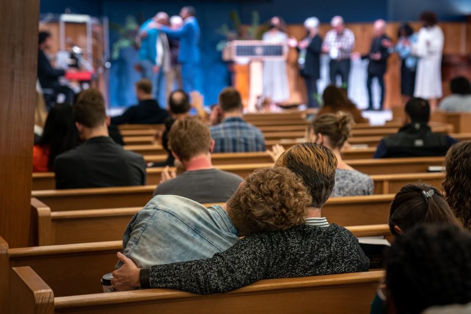 Congregation members embrace during a service at Koinonia Church in Nashville, Tenn., Sunday, April 2, 2023.