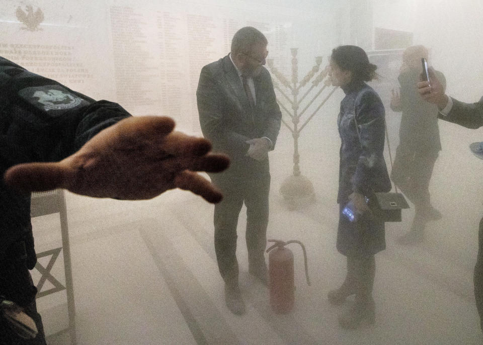 WARSAW, 2023: A far-right Polish lawmaker, left, after using a fire extinguisher on Hanukkah candles in parliament.<span class="copyright">Andrzej Iwanczuk—NurPhoto/Getty Images</span>