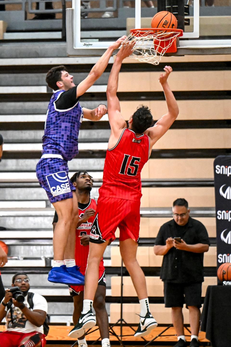 Michigan State and Team Case Credit Union's Frankie Fidler, left, dunks as his MSU teammate and Team Goodfellas' Szymon Zapala defends in the game on Tuesday, June 25, 2024, during the Moneyball Pro-Am at Holt High School.