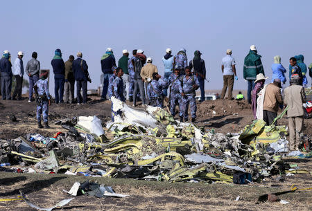 FILE PHOTO: Ethiopian Federal policemen stand at the scene of the Ethiopian Airlines Flight ET 302 plane crash, near the town of Bishoftu, southeast of Addis Ababa, Ethiopia March 11, 2019. REUTERS/Tiksa Negeri