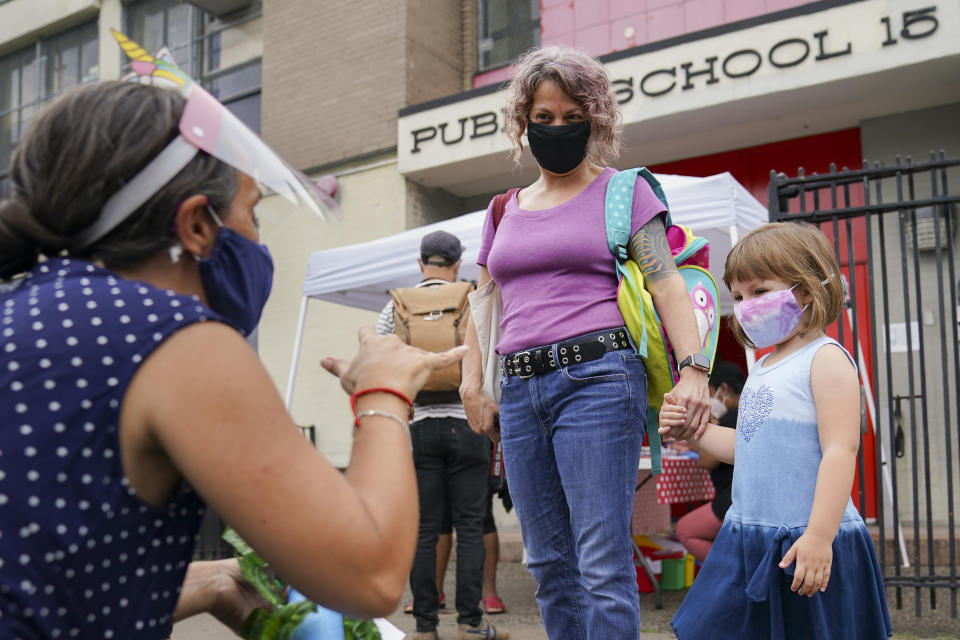 FILE- In this Sept. 2, 2020 file photo, teachers and students participate in an outdoor learning demonstration to display methods schools can use to continue on-site education during the coronavirus pandemic, at P.S. 15 in the Red Hook neighborhood of the Brooklyn borough of New York. New York City's already delayed school year is scheduled to start remotely on Wednesday, Sept. 16, 2020, in a soft opening that will serve as a prologue to the return of students to physical classrooms on the following week. (AP Photo/John Minchillo, File)