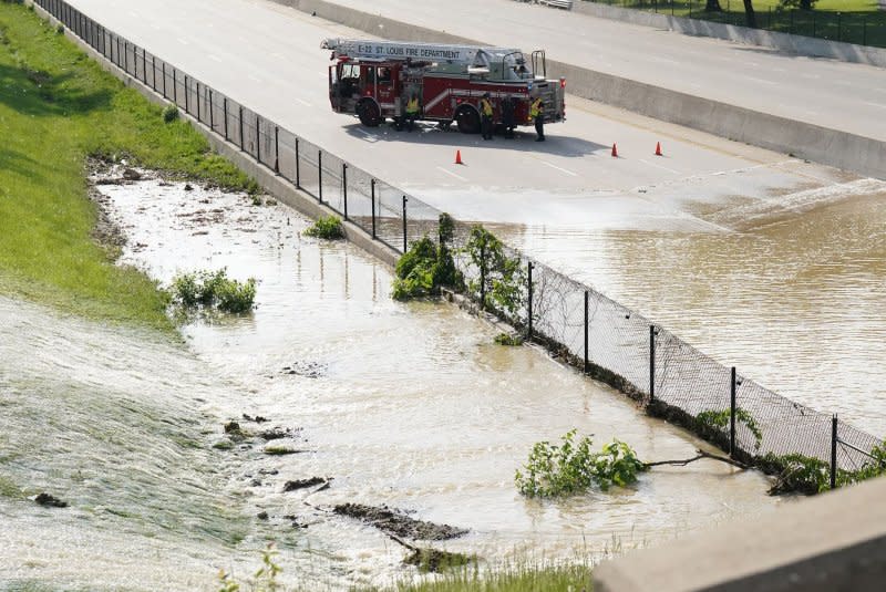 A St. Louis Fire Department pumper blocks the eastbound lanes of Highway 64 after a water main break floods the main main thoroughfare through St. Louis on May 12. File Photo by Bill Greenblatt/UPI
