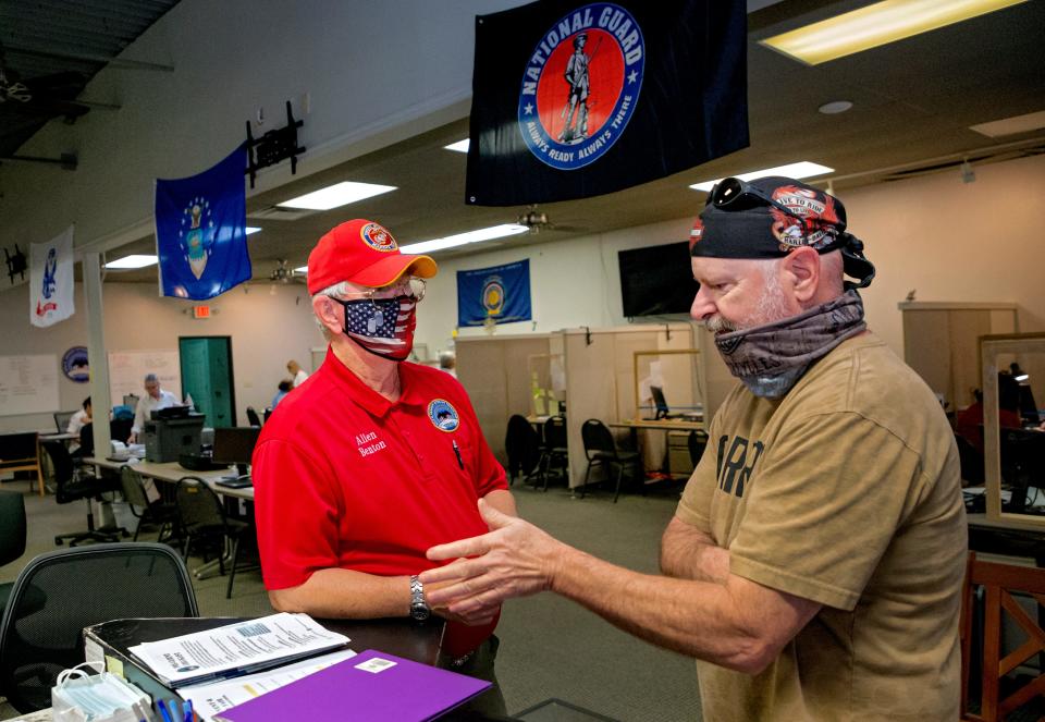 Allen Benton, client and volunteer at the Dale K. Graham Veterans Foundation, helps client Curtis Knapp at the organization's office in Norman on Thursday. Benton, who was on the verge of homelessness after returning from Vietnam, was able to get services from the foundation in obtaining 100% of his VA benefits.