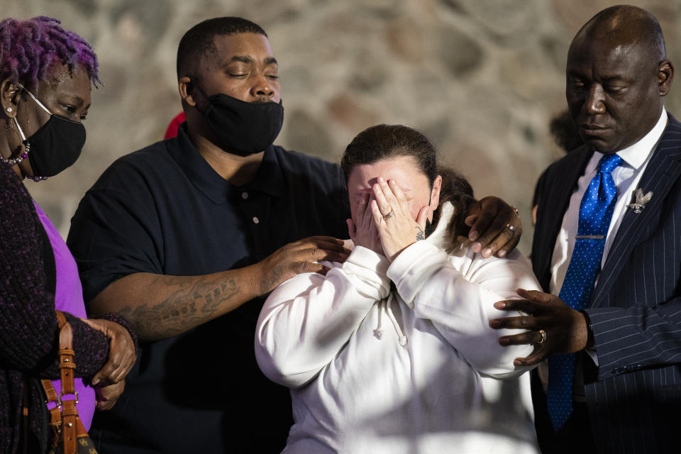 Katie Wright, mother of the deceased Daunte Wright, center, is comforted by her husband Aubrey, second from left, and attorney Ben Crump, right, after speaking during a news conference at New Salem Missionary Baptist Church, Thursday, April 15, 2021, in Minneapolis. (AP Photo/John Minchillo)