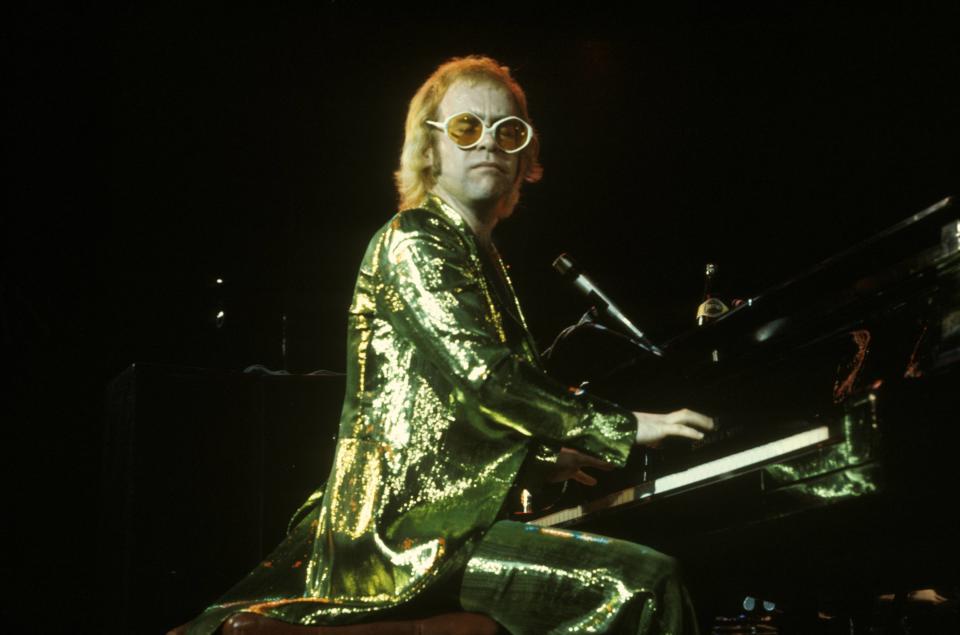 Elton John onstage in a sequined suit.