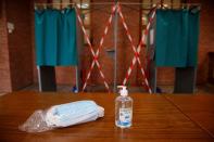 FILE PHOTO: Protective face masks and hydroalcoholic gel are seen at a polling station two days before the second round of mayoral elections