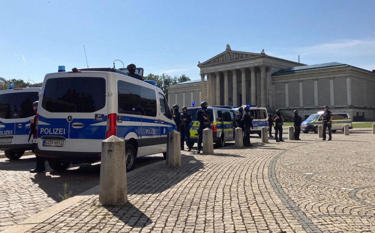 Police officers secure the area around the Koenigsplatz square after the incident