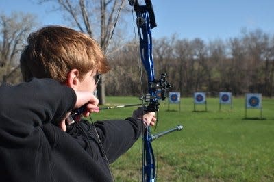 An archer takes aim during the state 4-H Archery Championships.