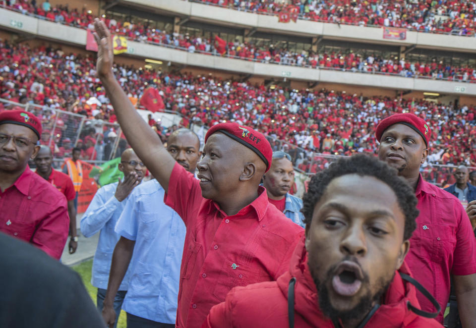 Leader of the Economic Freedom Fighters (EFF) party, Julius Malema, centre, greets supporters at their final election rally at Orlando Stadium in Soweto, South Africa, Sunday, May 5, 2019. Campaign rallies for South Africa's upcoming election have reached a climax Sunday with mass rallies by the ruling party and one of its most potent challengers. (AP Photo/Mujahid Safodien)