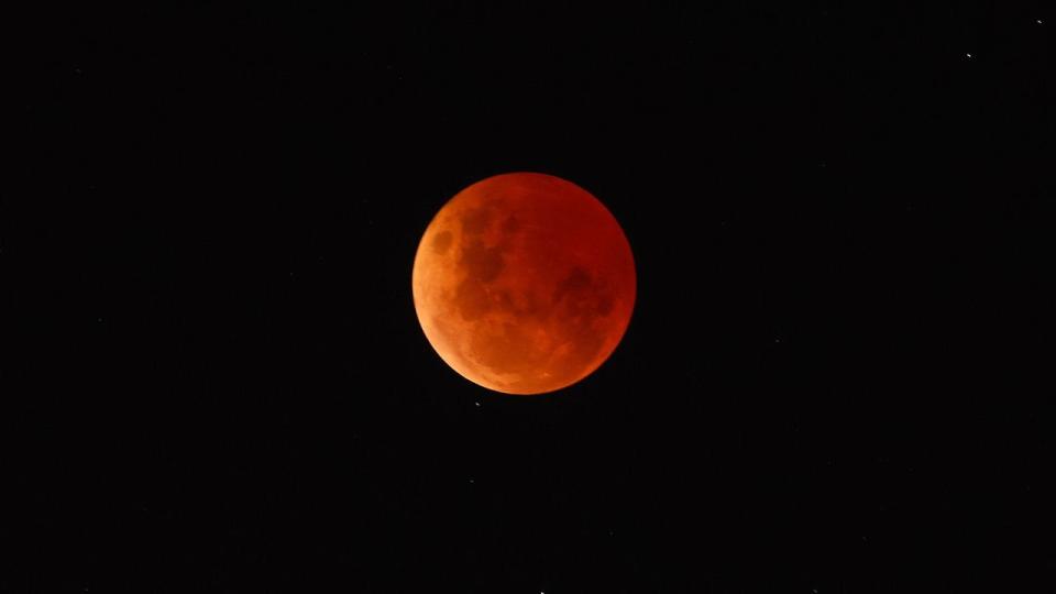 The 'Blood Moon' or lunar eclipse is seen from Williamstown on November 8, 2022, in Melbourne, Australia.