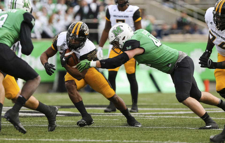 Marshall’s Blake Keller (44) attempts to bring down Southern Mississippi running back Ito Smith (25) in an NCAA college football game in Huntington, W.Va., Saturday, Nov. 25, 2017. Southern Mississippi won, 28-27. (Sholten Singer/The Herald-Dispatch via AP)