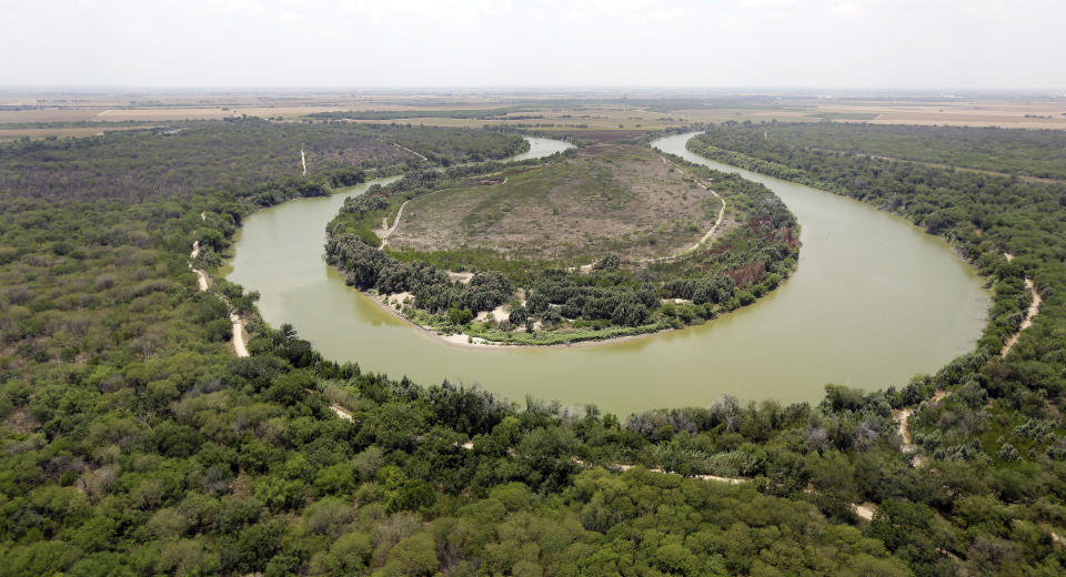 File - In this July 24, 2014, file photo, a bend in the Rio Grande is viewed from a Texas Department of Public Safety helicopter on patrol over in Mission, Texas. The Biden administration said Friday it will begin work to address risks of flooding and soil erosion from the unfinished wall on the U.S. border with Mexico and provided some answers on how it will use unspent money from shutting down one of President Donald Trump's signature domestic projects. Construction under the Trump administration "blew large holes" into the flood barrier system of low-lying regions in Texas' Rio Grande Valley, the Homeland Security Department said. It said it will "quickly repair" the flood barrier system without extending the wall. Hidalgo County, Texas, officials have expressed alarm about flooding risks during the hurricane season starting in June from breaches in a levee system after Biden halted border wall construction immediately after taking office in January. (AP Photo/Eric Gay, Pool, File)