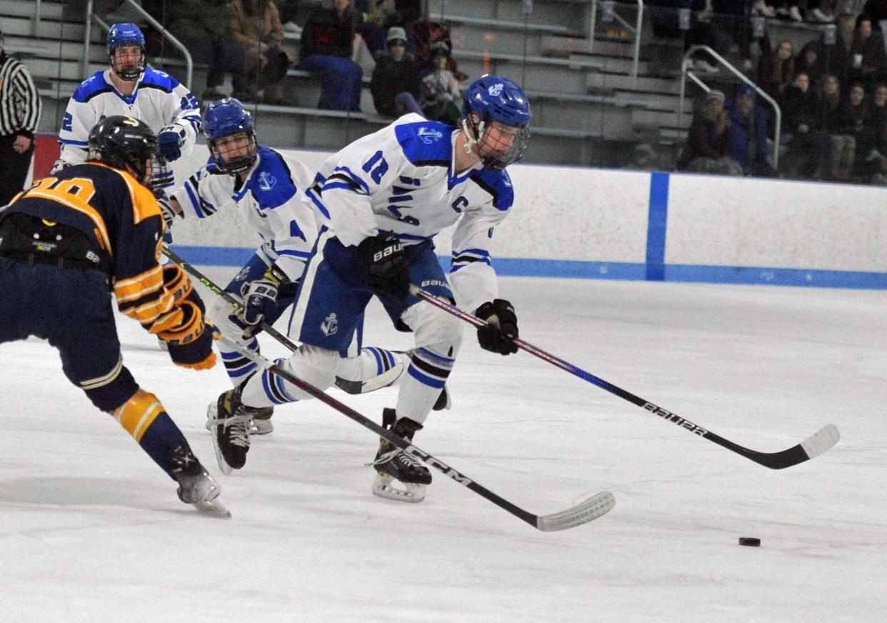 Scituate's James Sullivan right, gets the puck away from Hanover's Pierceson Lee, left, during boys high school hockey action at the Hobomock Arena in Pembroke, Wednesday, Feb. 7, 2024.