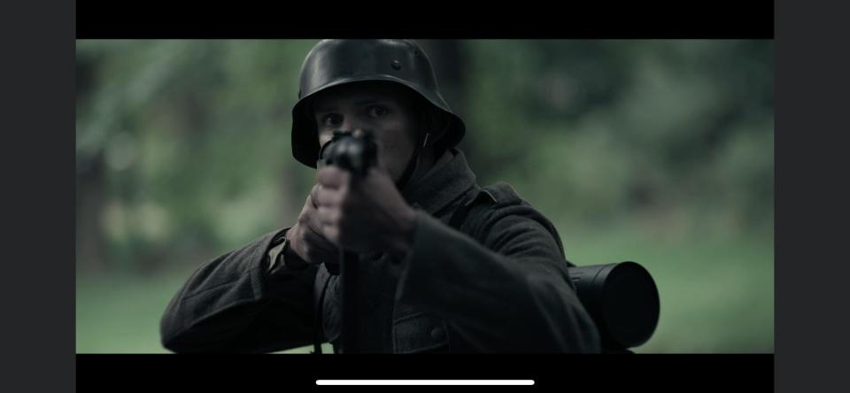 A soldier fires a weapon in a still from "Quarter Given," a World War II film that was filmed in Portage County.