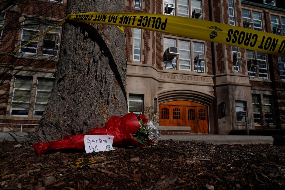 A bouquet rests by police tape surrounding Berkey Hall following an active shooting incident on the Michigan State University campus in East Lansing on Tuesday, February 14, 2023, that left three dead and multiple injured.