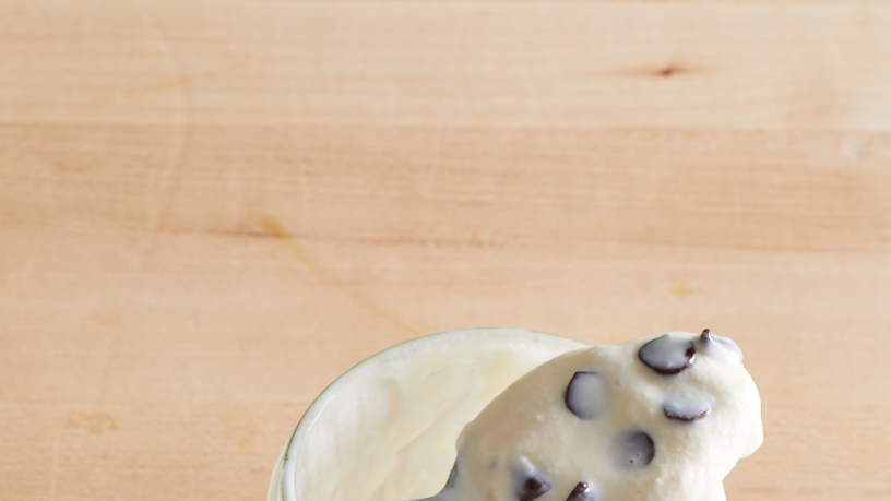 a jar of ice cream with a spoon of ice cream resting on the top