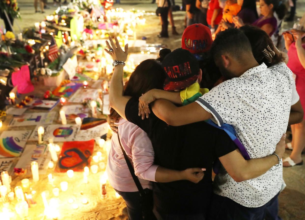 Mourners hug as they pay their respects at a memorial for the victims of the Pulse gay nightclub shooting in Orlando, Fla. (Photo: Joe Raedle/Getty Images)