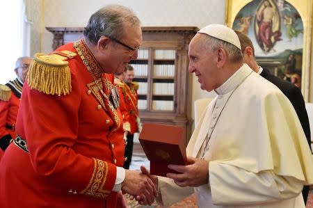 FILE PHOTO: Pope Francis (R) exchanges gifts with Robert Matthew Festing, Prince and Grand Master of the Sovereign Order of Malta during a private audience at the Vatican June 23, 2016. REUTERS/Gabriel Bouys/Pool