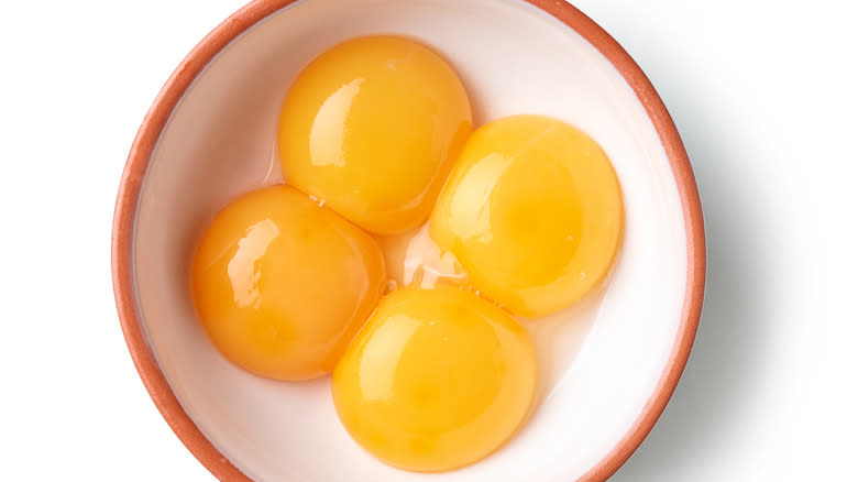 Four egg yolks in bowl 