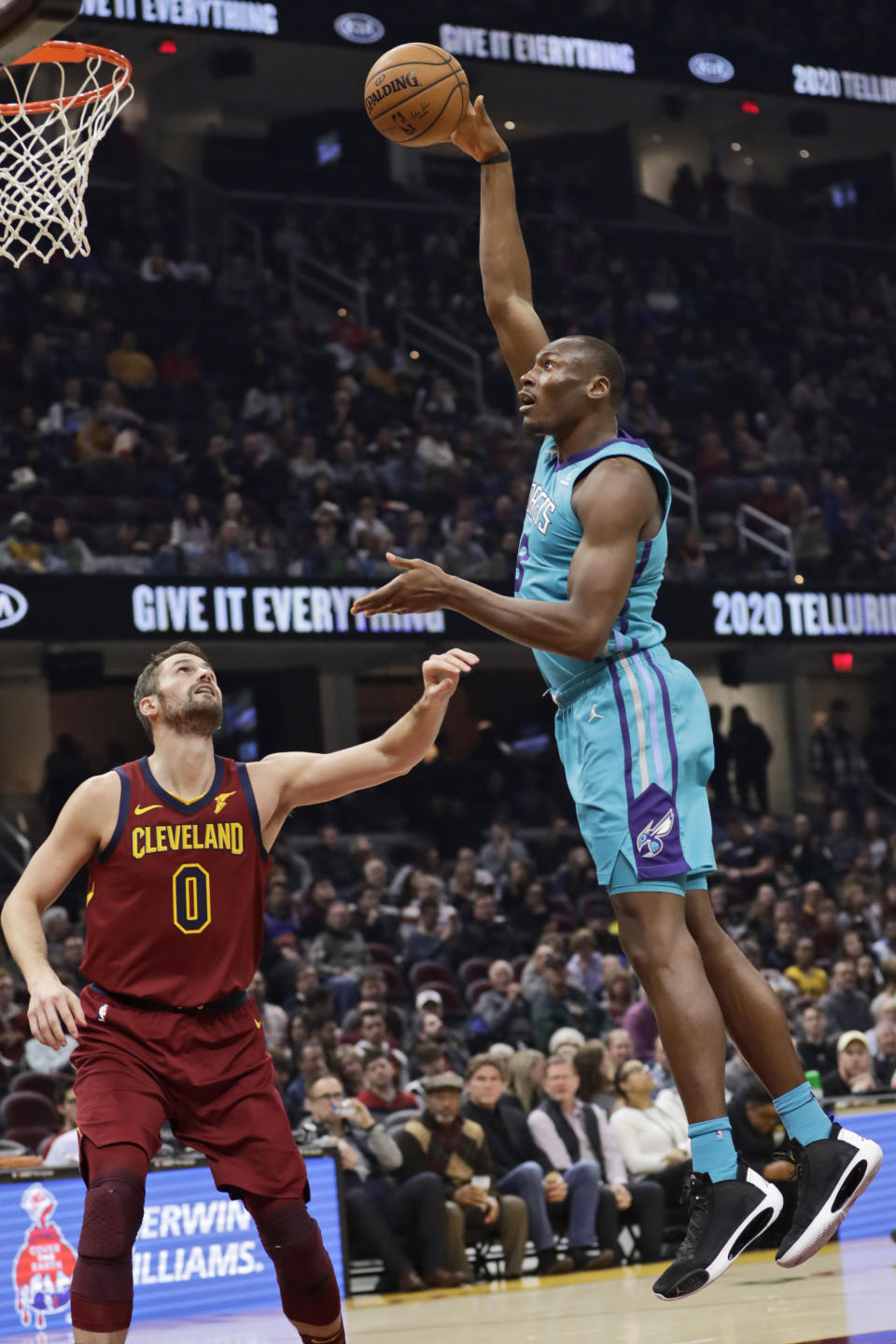 Charlotte Hornets' Bismack Biyombo (8) shoots over Cleveland Cavaliers' Kevin Love (0) in the second half of an NBA basketball game, Thursday, Jan. 2, 2020, in Cleveland. (AP Photo/Tony Dejak)