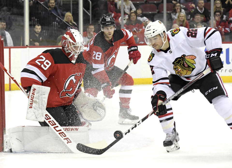 Chicago Blackhawks center Ryan Carpenter (22) skates in against New Jersey Devils goaltender Mackenzie Blackwood (29) during the first period of an NHL hockey game Friday, Dec. 6, 2019, in Newark, N.J. (AP Photo/Bill Kostroun)