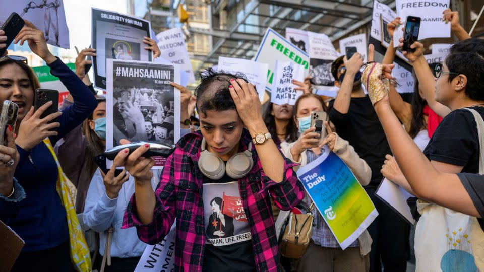 Activist Forouzan Farahani shaves her head in protest over the death of Mahsa Amini in Iran outside The New York Times building in New York City on September 27, 2022. - Angela Weiss/AFP via Getty Images