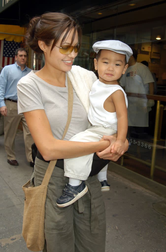 Angelina Jolie holding a baby Maddox in her arms