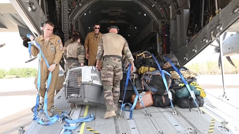 In this image from video provided by the French Armed Forces, military personnel load belongings of evacuees onto a plane at the airport in Khartoum, Sudan, on Sunday, April 23, 2023. Foreign nationals were flown out of the country, as forces loyal to rival generals battled for control of Africa's third-largest nation for a ninth day amid fading hopes for deescalation. (French Armed Forces via AP)