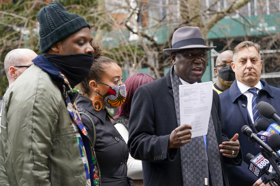 Attorney Ben Crump, second from right, is joined by Attorney Paul Napoli, right, Keyon Harrold Sr., left, and Katty Rodriguez as he holds a copy of a lawsuit while speaking to reporters during a news conference to announce the filing of a lawsuit against Arlo Hotels and Miya Ponsetto, Wednesday, March 24, 2021, in New York. Keyon Harrold and his son were allegedly racially profiled in an Arlo hotel in Manhattan by Miya Ponsetto in December 2020. Ponsetto wrongly accused Keyon Harrold Jr. of stealing her phone and physically attacking him. (AP Photo/Mary Altaffer)