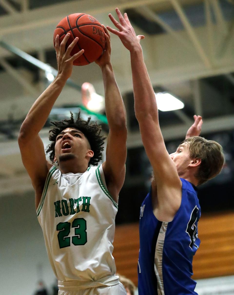 Oshkosh North's Xzavion Mitchell puts up a shot against Oshkosh West's Tristan Johanknecht during a game on Jan. 14. Mitchell and Johanknecht are top returning players for their respective teams this season.