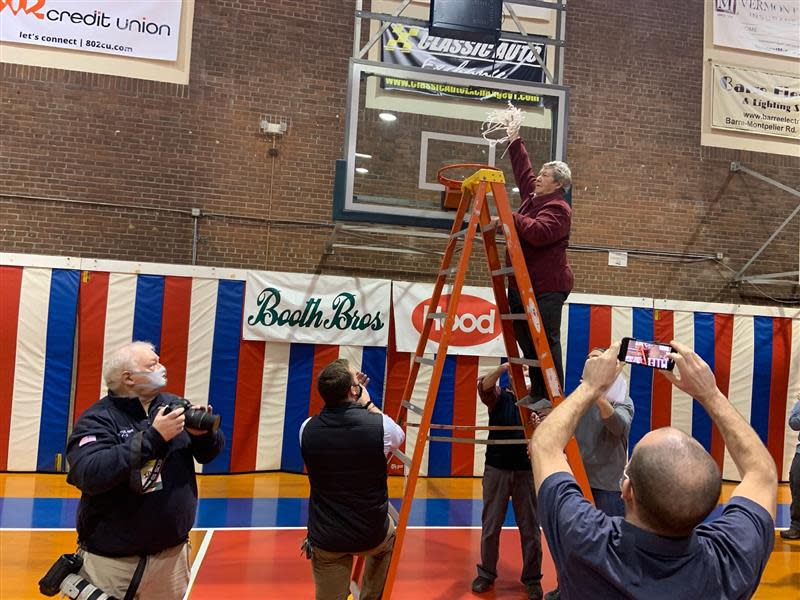 Longtime Mount Abraham coach, Connie LaRose cuts down the net after winning the Division II girls basketball championship on March 5, 2022 at Barre Auditorium.