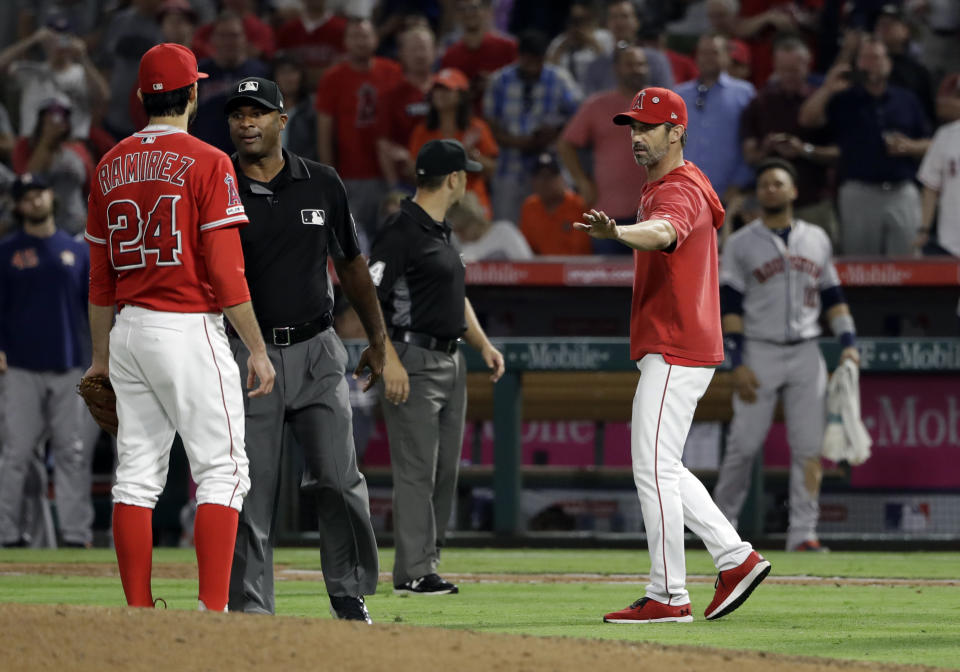 Los Angeles Angels manager Brad Ausmus right, gestures to pitcher Noe Ramirez (24) after Ramirez hit Houston Astros' Jake Marisnick with a pitch during the sixth inning of a baseball game Tuesday, July 16, 2019, in Anaheim, Calif. (AP Photo/Marcio Jose Sanchez)