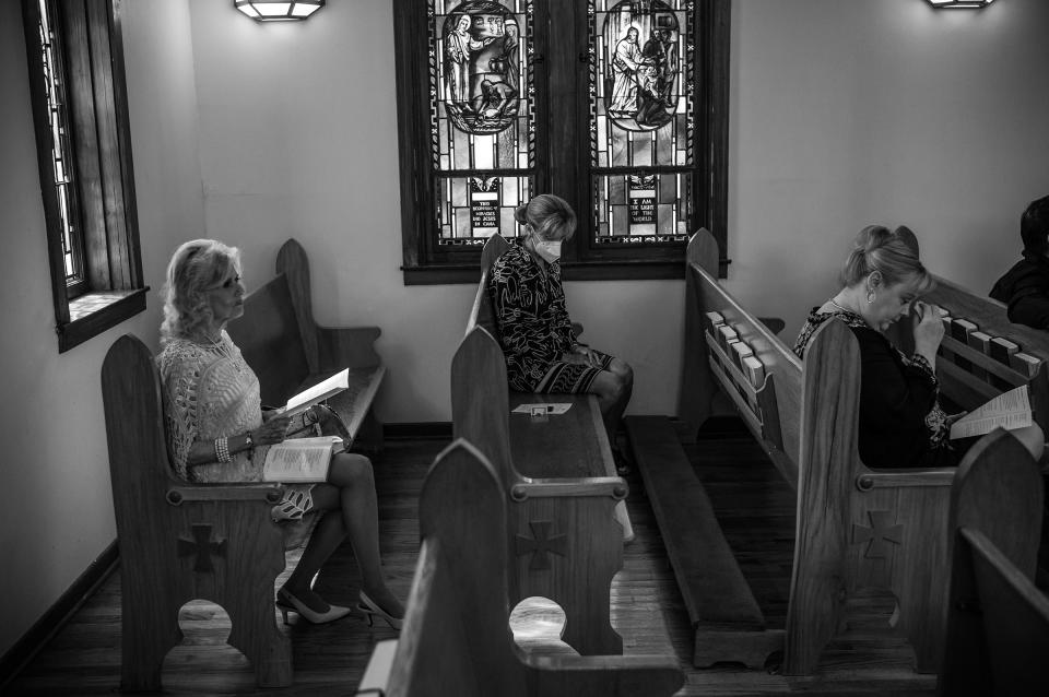 Three woman listen to a sermon at St. Philip's Episcopal Church on May 29, 2022.<span class="copyright">David Butow for TIME</span>