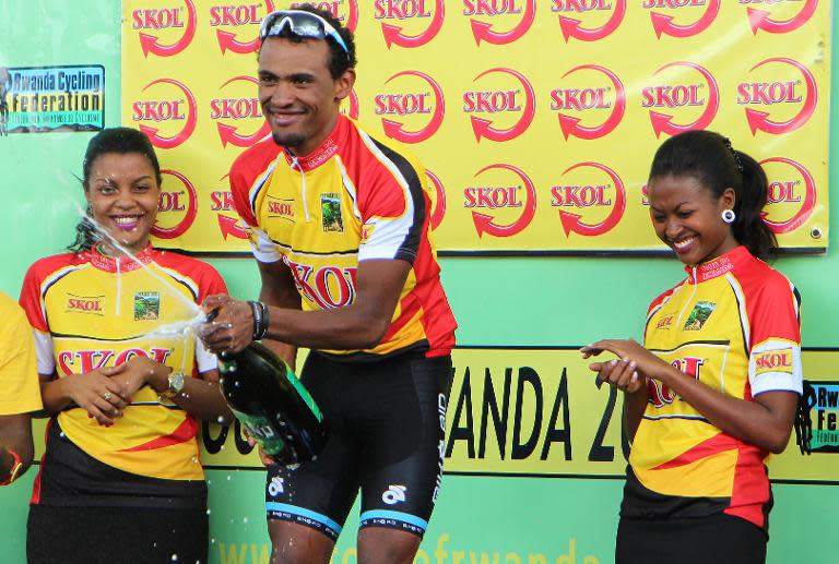 Eritrean cyclist Mekseb Debesay, winner of the first stage of the Tour of Rwanda, celebrates on the podium in Kigali on November 17, 2014