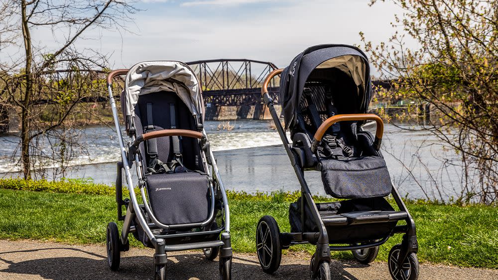 a nuna stroller and uppababy stroller placed next to each other outside