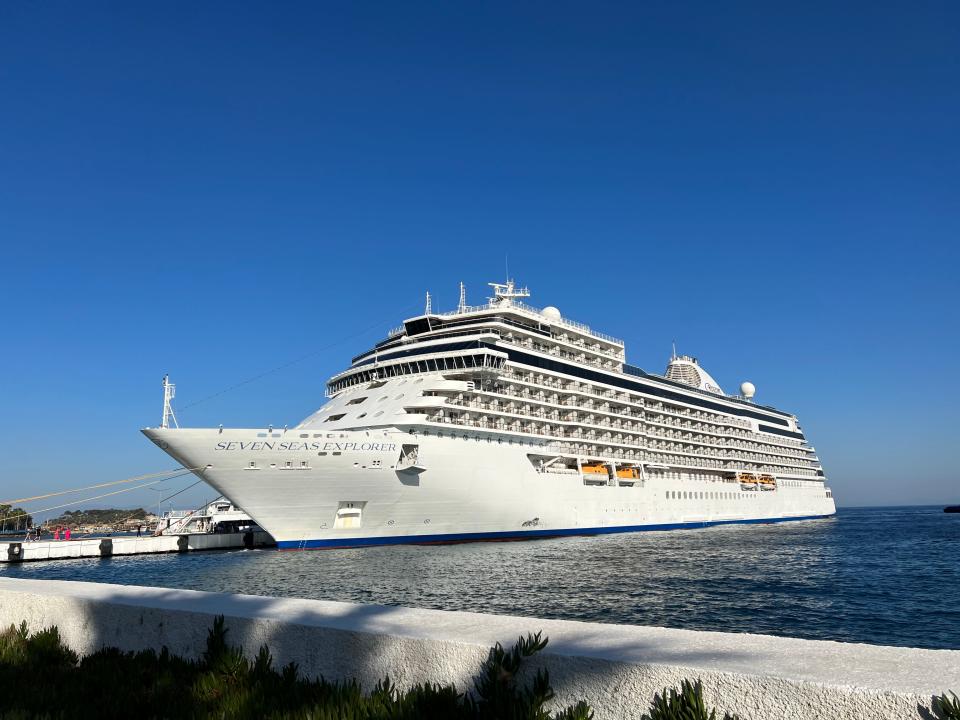 regent seven seas cruise ship docked at a port on a clear day