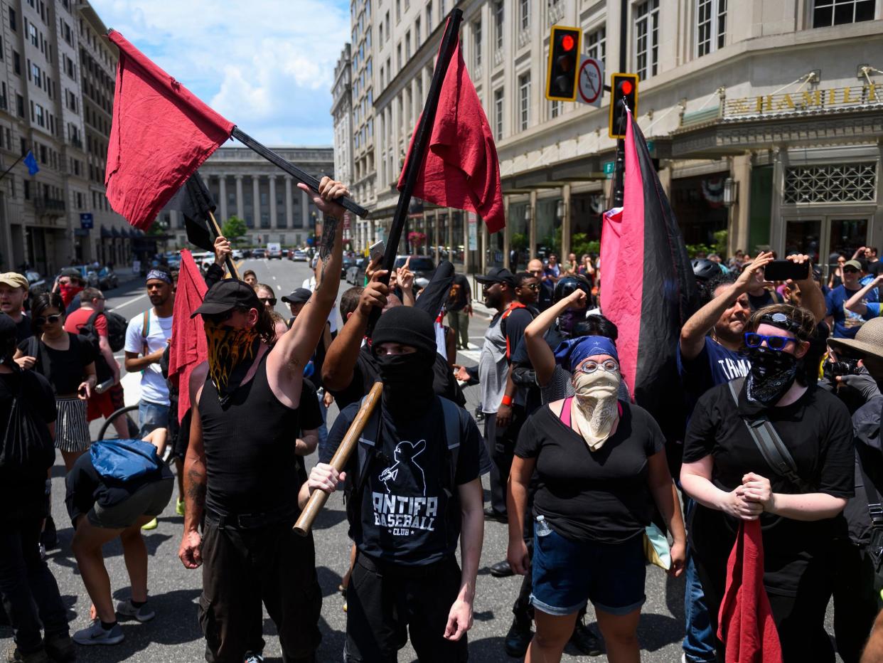 Members of an anti-fascist or Antifa group march as the Alt-Right movement gathers for a "Demand Free Speech" rally: AFP/Getty