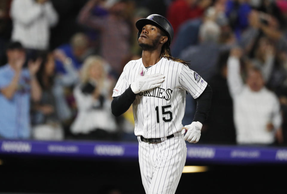 Colorado Rockies pinch hitter Raimel Tapia gestures as he circles the bases after hitting a grand slam off Milwaukee Brewers relief pitcher Jay Jackson in the sixth inning of a baseball game Friday, Sept. 27, 2019, in Denver. (AP Photo/David Zalubowski)