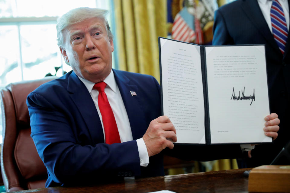 President Donald Trump displays an executive order imposing fresh sanctions on Iran in the Oval Office on June 24, 2019. Reuters/Carlos Barria